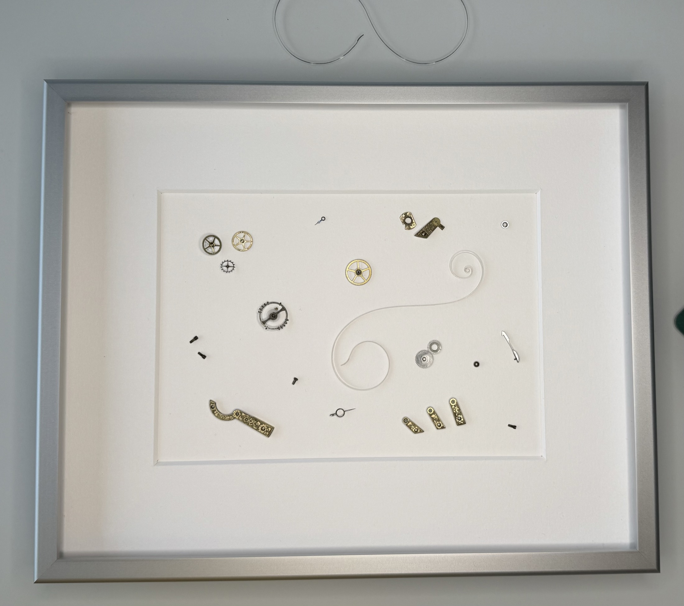 Gerahmte Arbeit mit Spirale und goldenen Zahnrädern